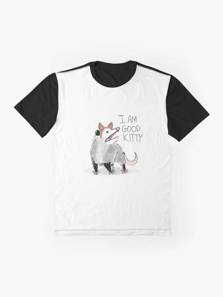 A graphic t-shirt with the text "I AM GOOD KITTY" and an opossum or possum design. - Flat lay