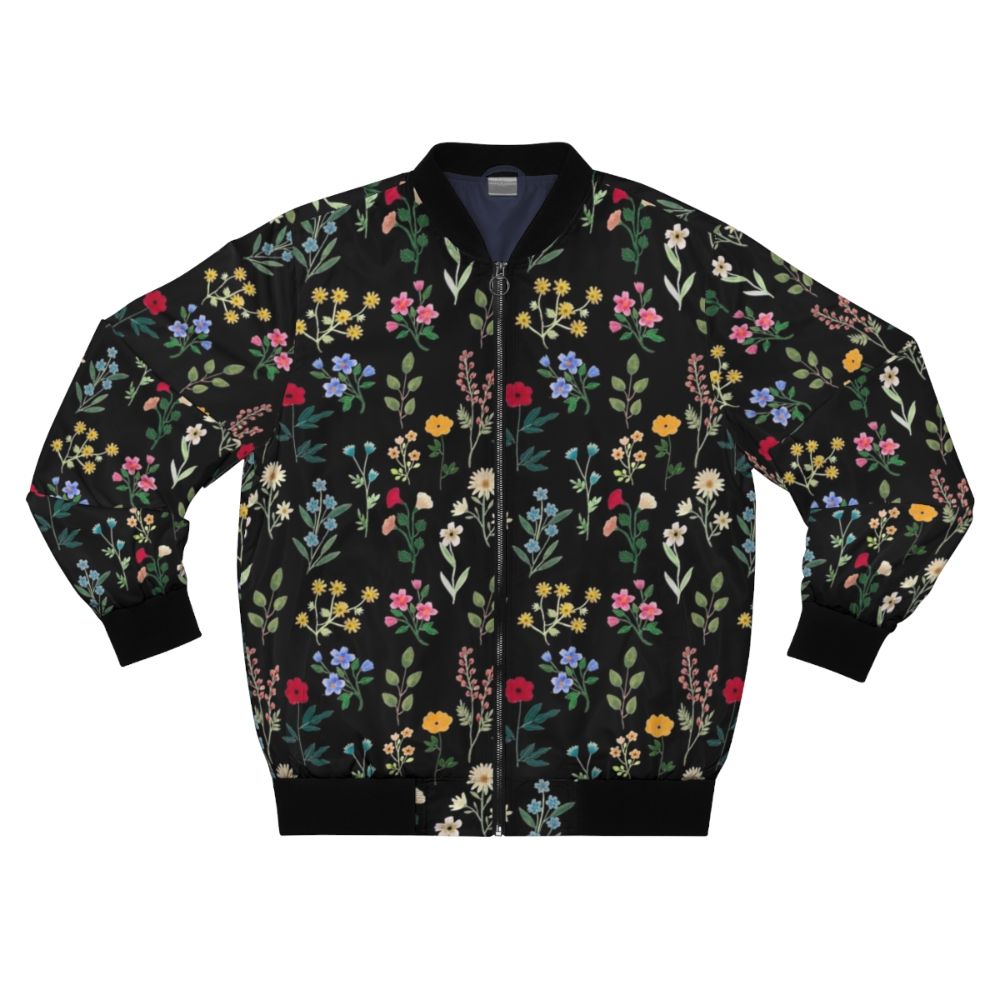 A black bomber jacket featuring a vibrant floral and botanical watercolor pattern design.