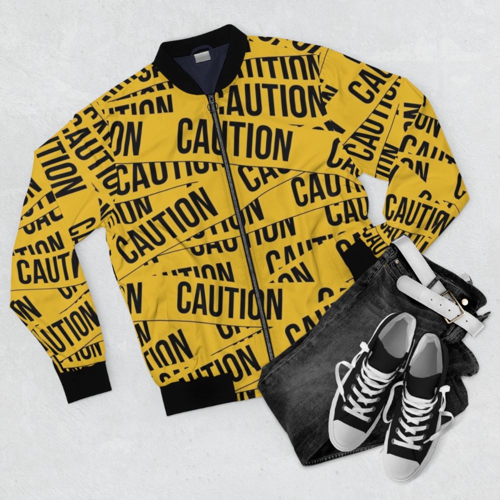 Caution bomber jacket with police tape design and warning graphics - Flat lay