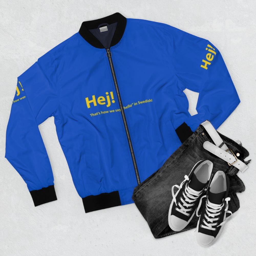 Swedish-inspired bomber jacket in yellow and blue with text and graphics. - Flat lay