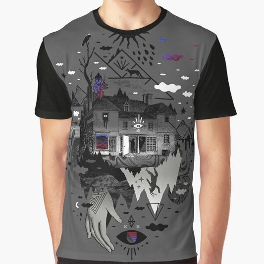 A surreal, abstract graphic tee featuring a collage-style design with a house, mountains, stars, moon, and other mystical elements.