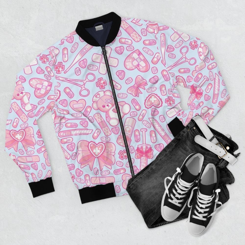 A pastel pink and white bomber jacket with a sickly sweet, creepy cute design featuring medical elements like pills and a hospital theme. - Flat lay