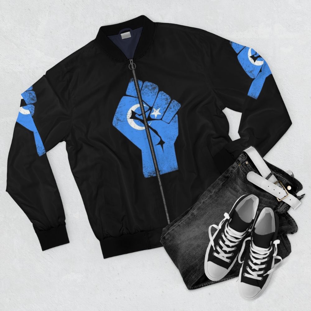 Free the Uyghurs bomber jacket with text and graphics supporting the Uyghur people - Flat lay