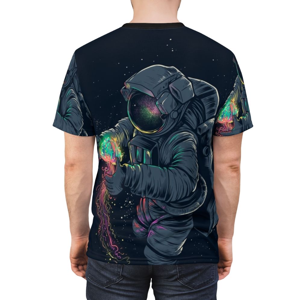 Model wearing a t-shirt featuring a colorful, intergalactic jellyfish design against a starry space backdrop. - men back