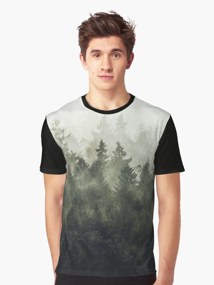 A green graphic t-shirt featuring a vintage-style illustration of a foggy, misty mountain landscape. - Men