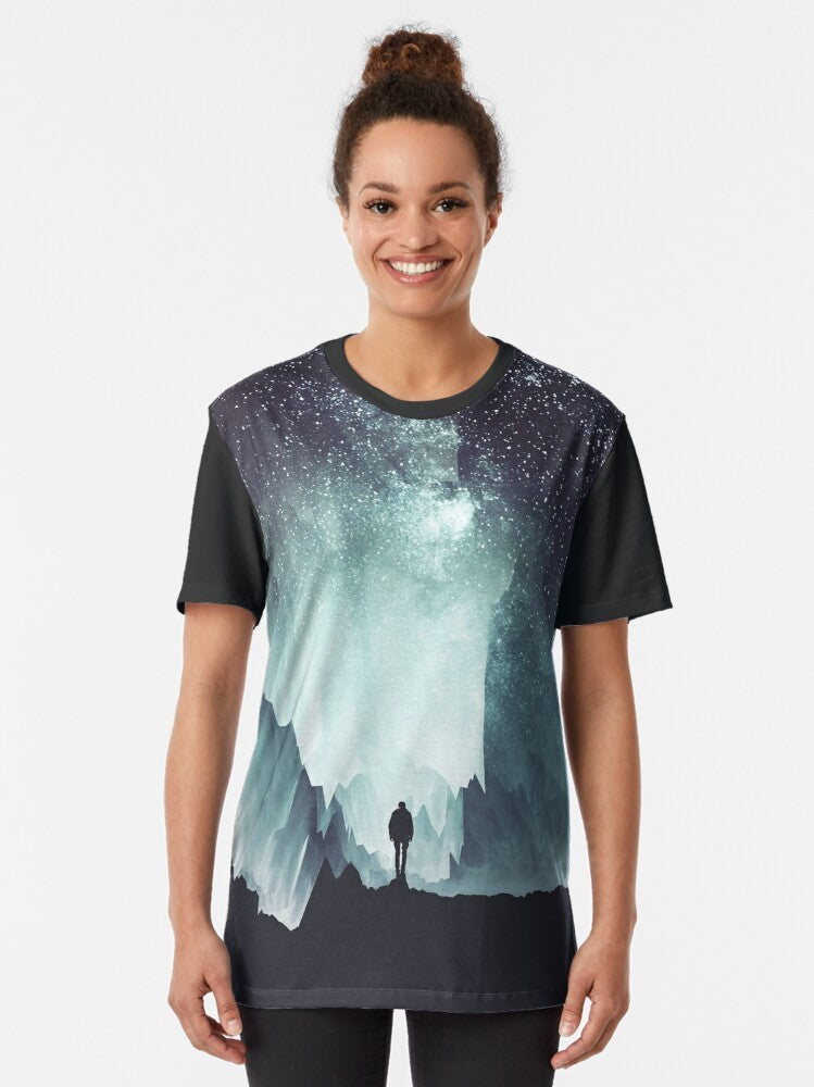 A northern, galaxy-inspired graphic t-shirt with a surreal, nature-themed design. - Women