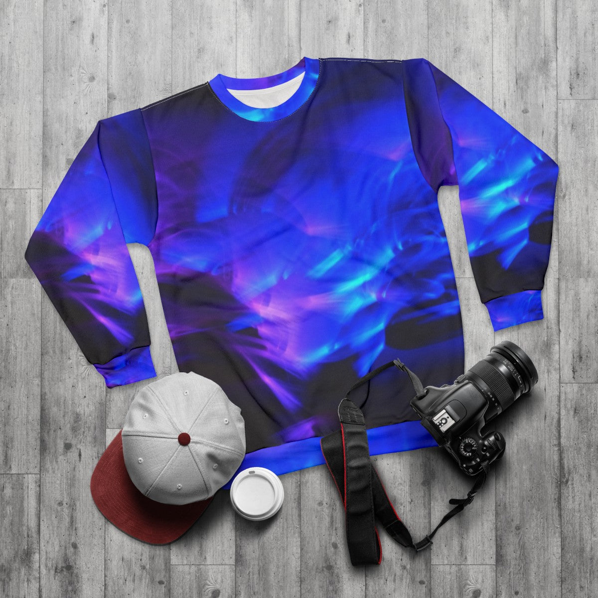 Glow in the dark sweatshirt with vibrant, swirling design - flat lay