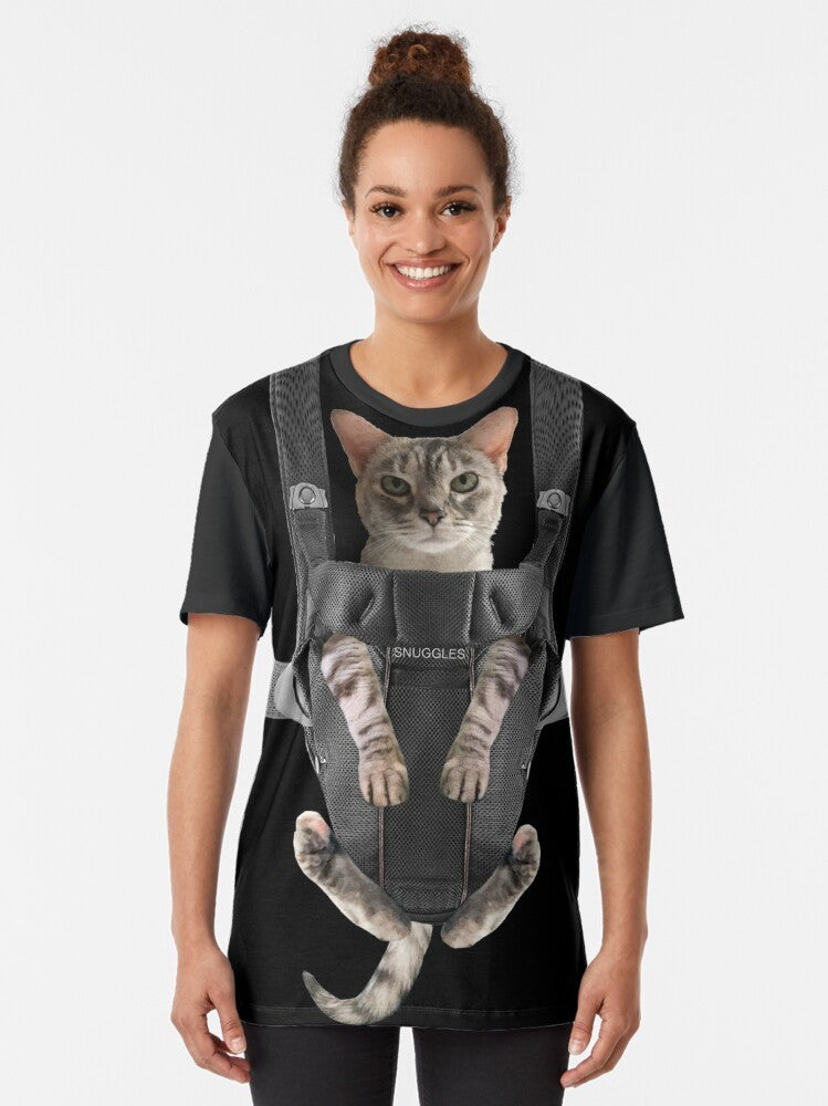 A cute and funny graphic of a gray cat snuggled up in a baby carrier. - Women