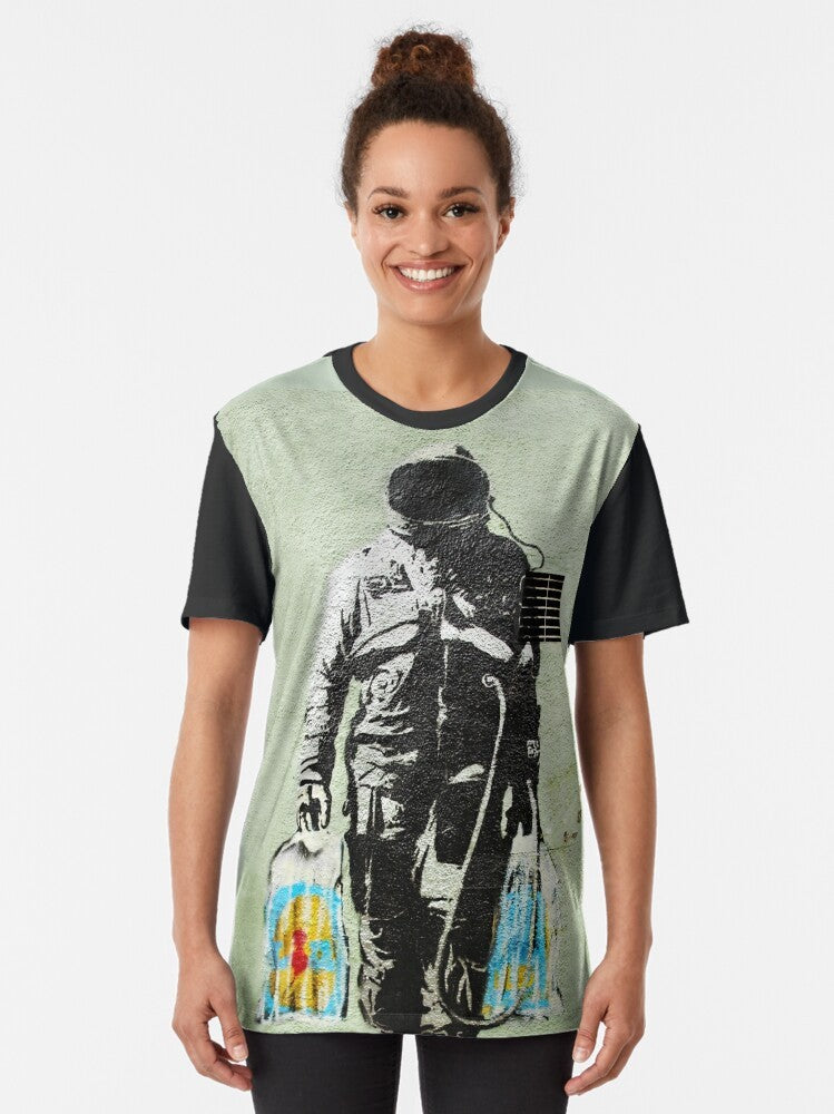 Banksy-inspired graphic t-shirt featuring an astronaut carrying shopping bags, a commentary on consumerism and society. - Women