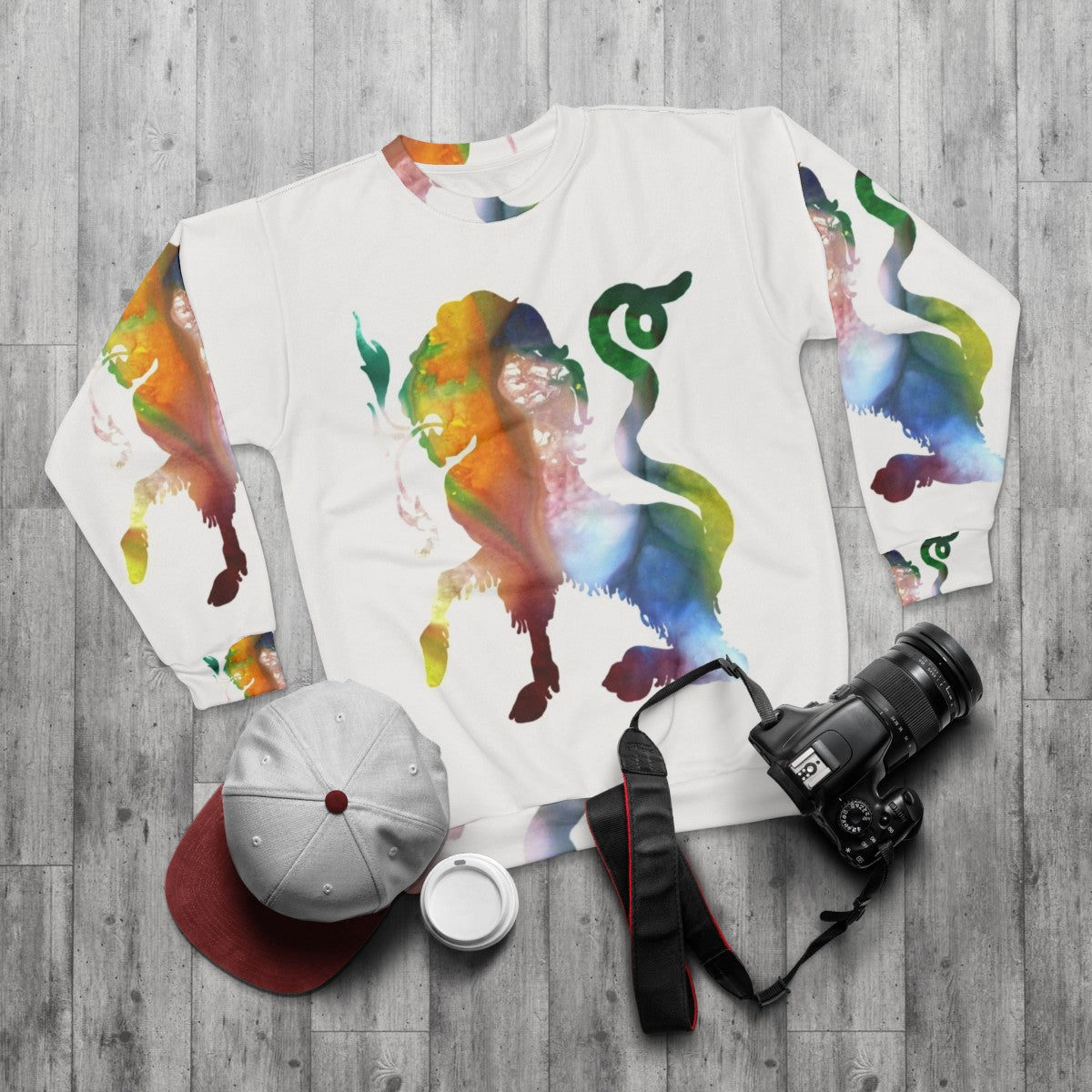 Watercolor illustration of a colorful chimera, a mythical Greek creature, on a sweatshirt - flat lay