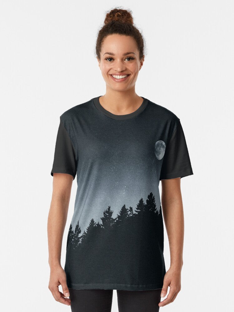 Mysterious night sky graphic t-shirt featuring a landscape with Cascadia trees, a supermoon, and astrological symbols - Women