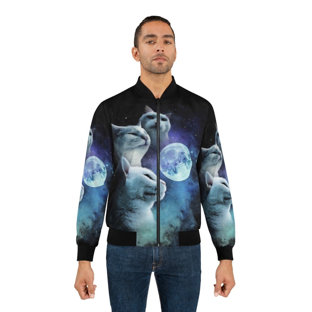 A bomber jacket featuring a vibrant design of cats vibing against a cosmic galaxy background, with a three-cat moon motif. - Lifestyle