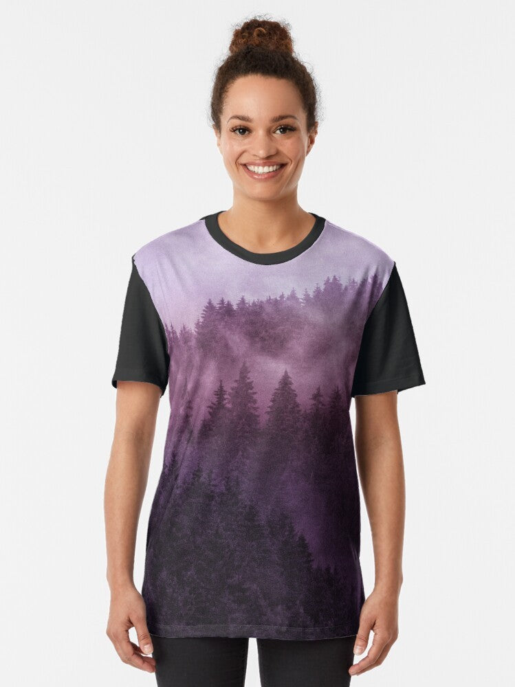 Graphic t-shirt with a design featuring a foggy, misty forest in a wilderness setting - Women