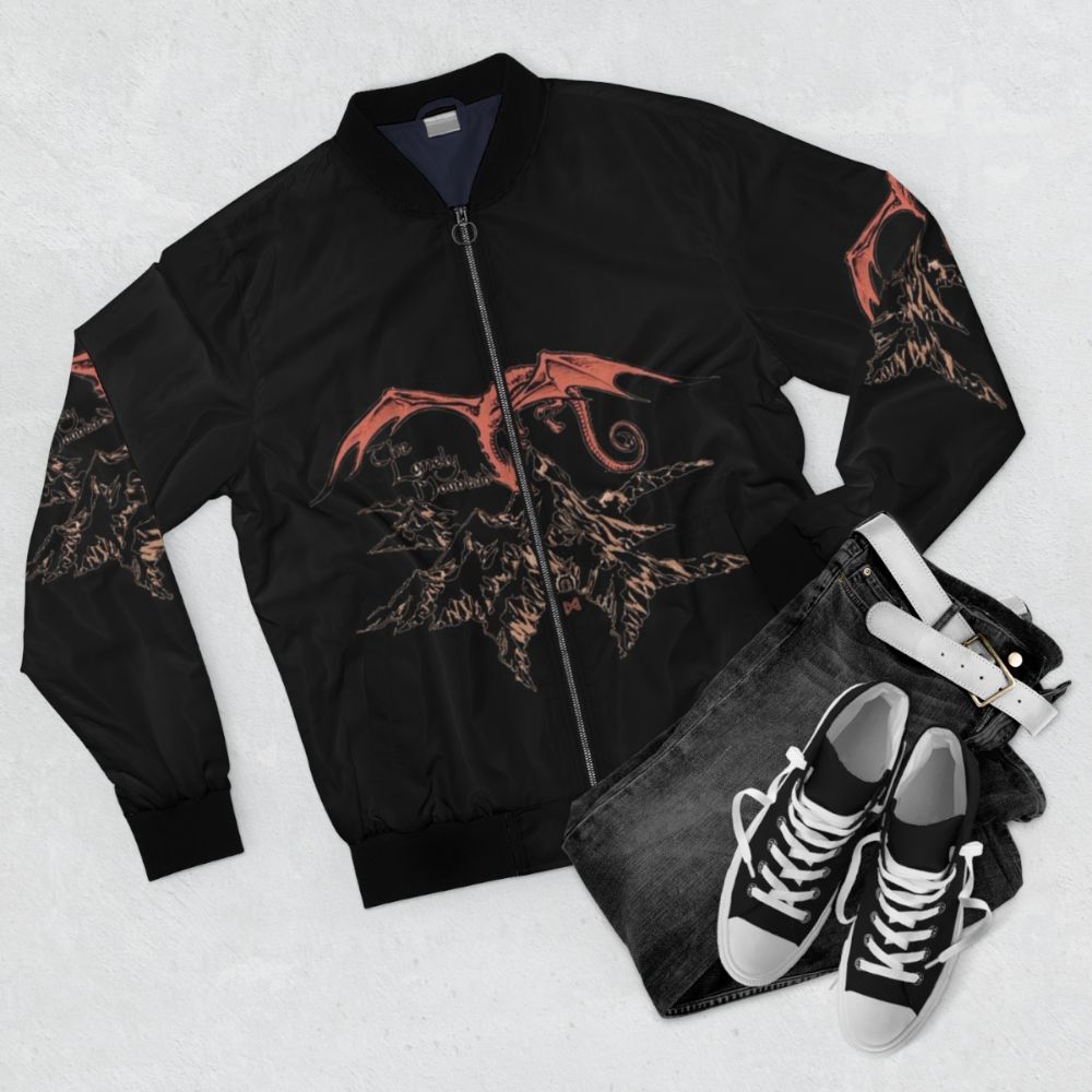 A bomber jacket featuring a dragon design, inspired by the works of J.R.R. Tolkien and the Lord of the Rings fantasy universe. - Flat lay