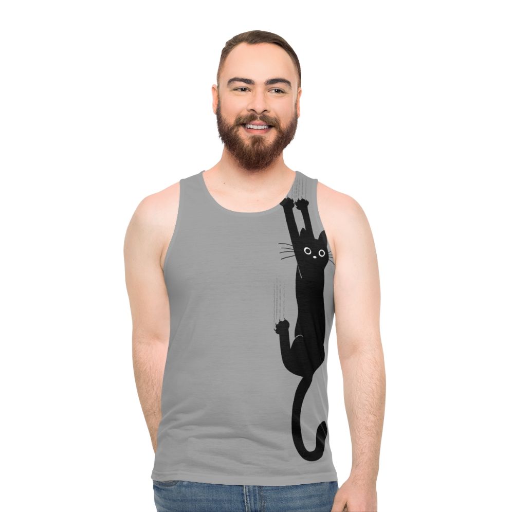 Black cat hanging on to tank top - men