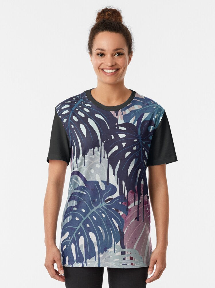 Monstera Melt Graphic T-Shirt featuring a surreal, melting tropical leaf design in blue and pink - Women