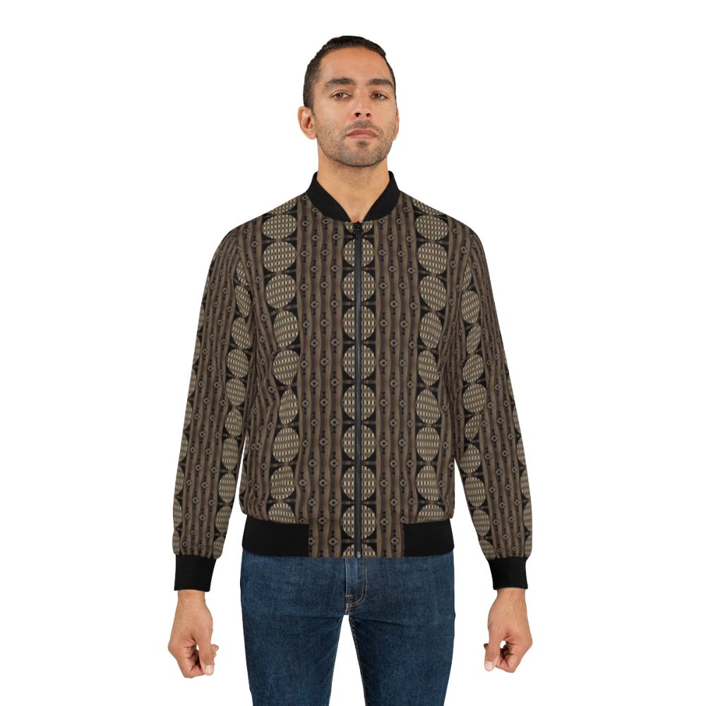 Primal patterns in gold, brown, and black bomber jacket designed by Helena Tiainen - Lifestyle