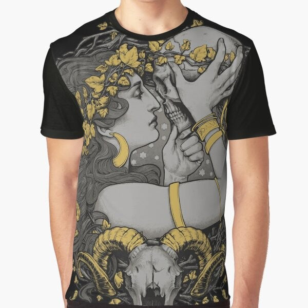 A gothic graphic t-shirt featuring a witch design with a ram skull, human skull, and botanical elements