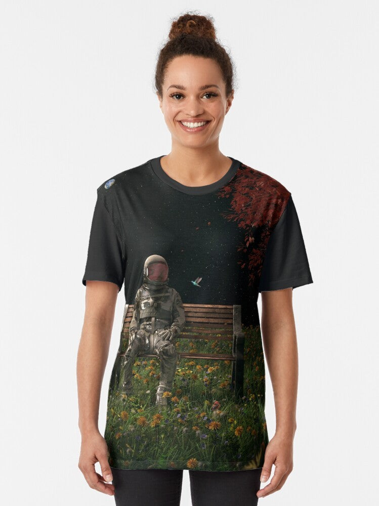 Surreal graphic t-shirt featuring an astronaut in a cosmic, nature-inspired landscape - Women