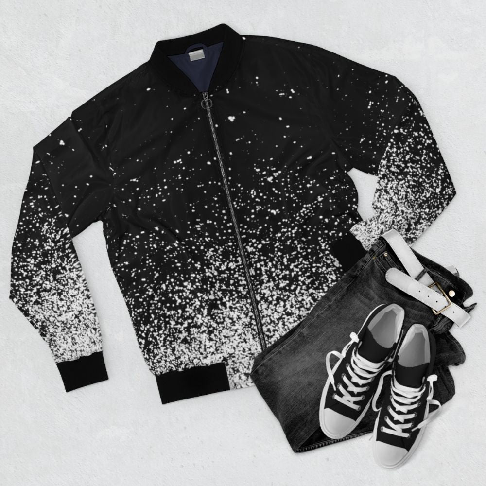 Abstract and modern bomber jacket with space-inspired design featuring ombre, stars, and sparks - Flat lay