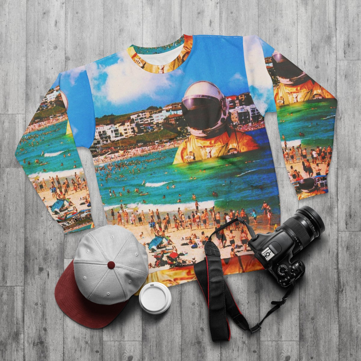 Surreal digital art sweatshirt featuring a beach astronaut in a collage design - flat lay