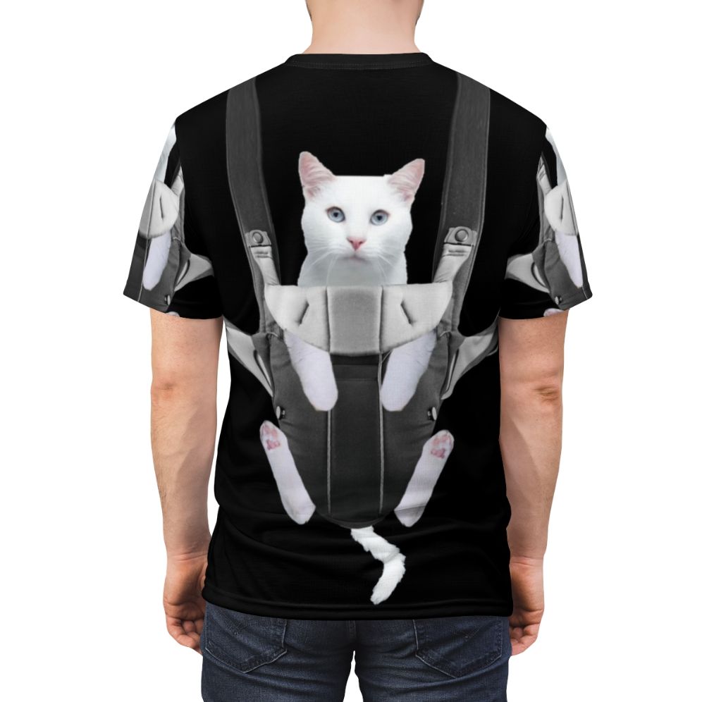 Image of a tabby cat sitting comfortably in a baby carrier against a white background - men back