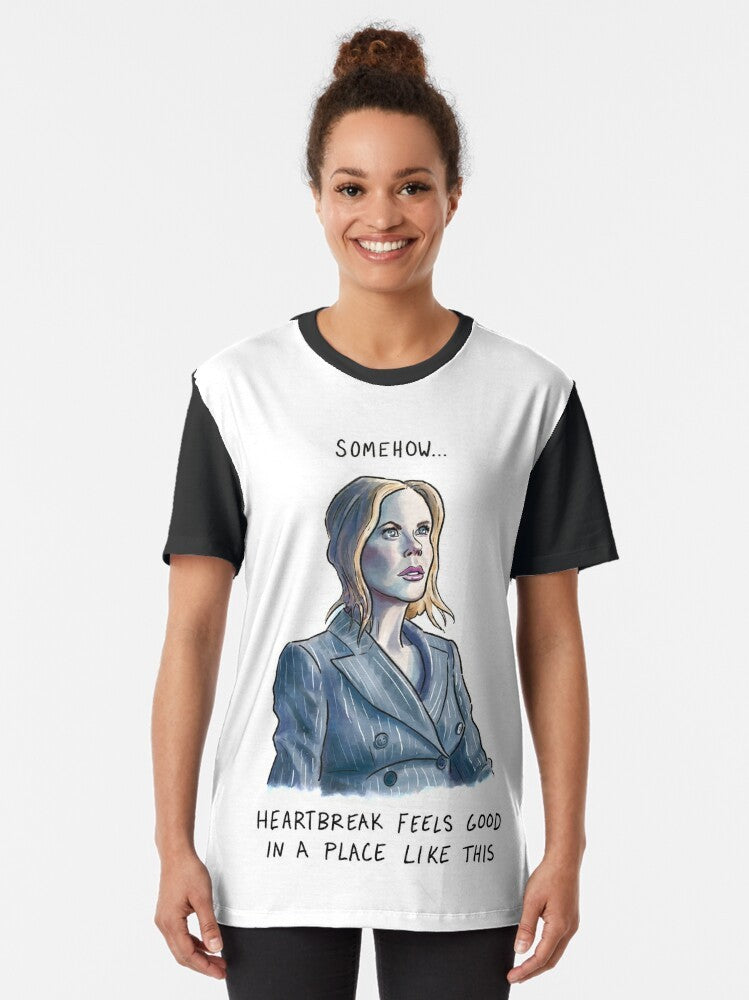 Nicole Kidman wearing a graphic t-shirt with the AMC logo and text "Heartbreak Feels Good" - Women