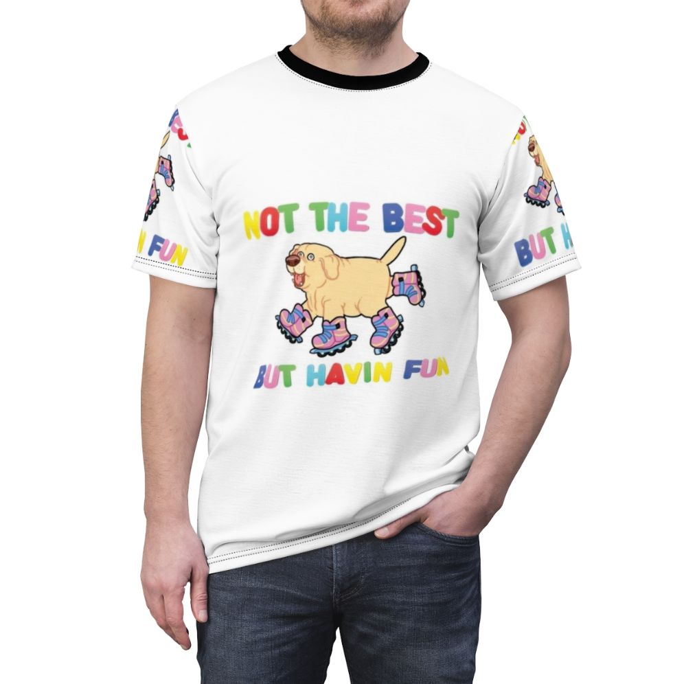 An AOP (all-over print) t-shirt featuring a playful dog on rollerskates or rollerblades, with the text "Not the best, but having fun". - men front