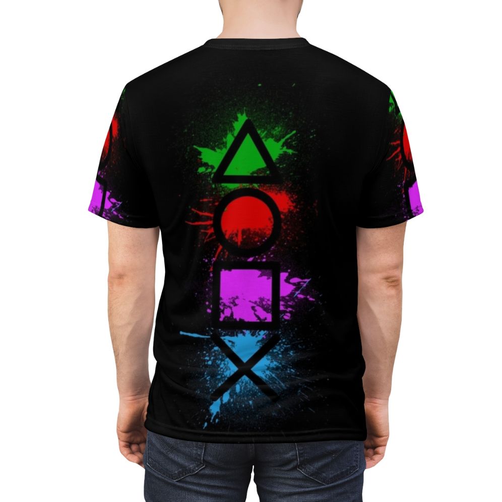 Graphic t-shirt featuring a splatter design of classic video game controller buttons - men back