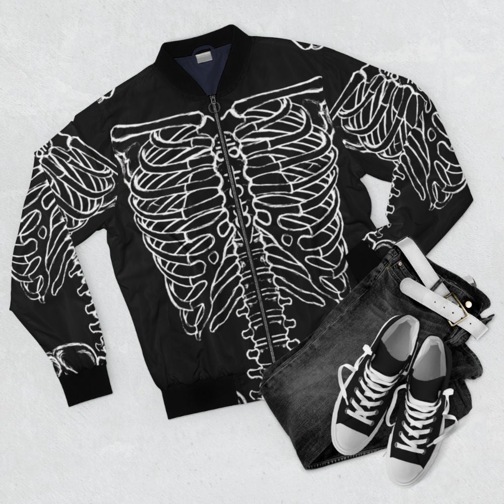 A black bomber jacket featuring a skeleton rib cage design, perfect for a dark and spooky Halloween look. - Flat lay