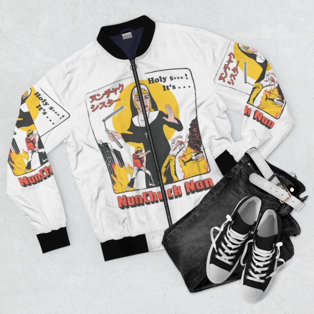 A colorful bomber jacket featuring a "Nunchuck Nun" design, a humorous pop culture parody. - Flat lay