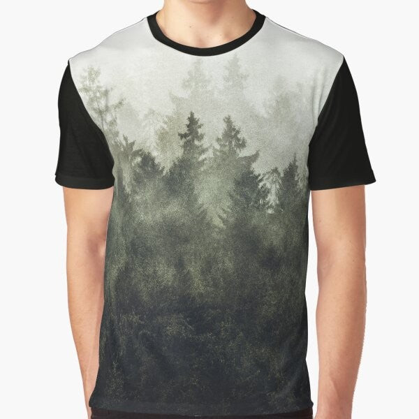 A green graphic t-shirt featuring a vintage-style illustration of a foggy, misty mountain landscape.