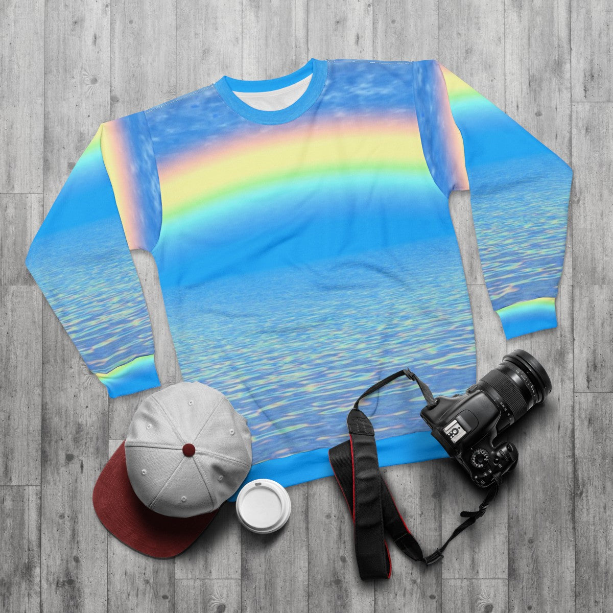 Colorful rainbow sweatshirt with abstract patterns - flat lay