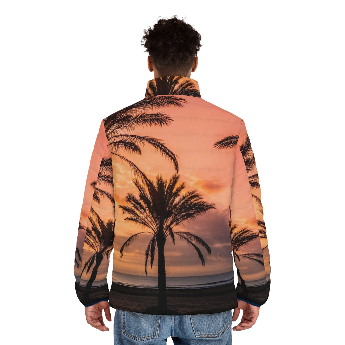 A person wearing a puffer jacket with a scenic view of the sun rising among palm trees on a beach - men back