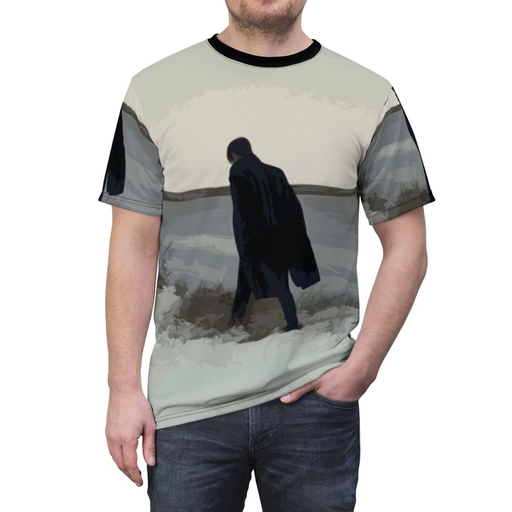 A t-shirt design featuring a minimalist figure in a coat, inspired by the emotional and introspective music of British singer-songwriter James Blake. - men front