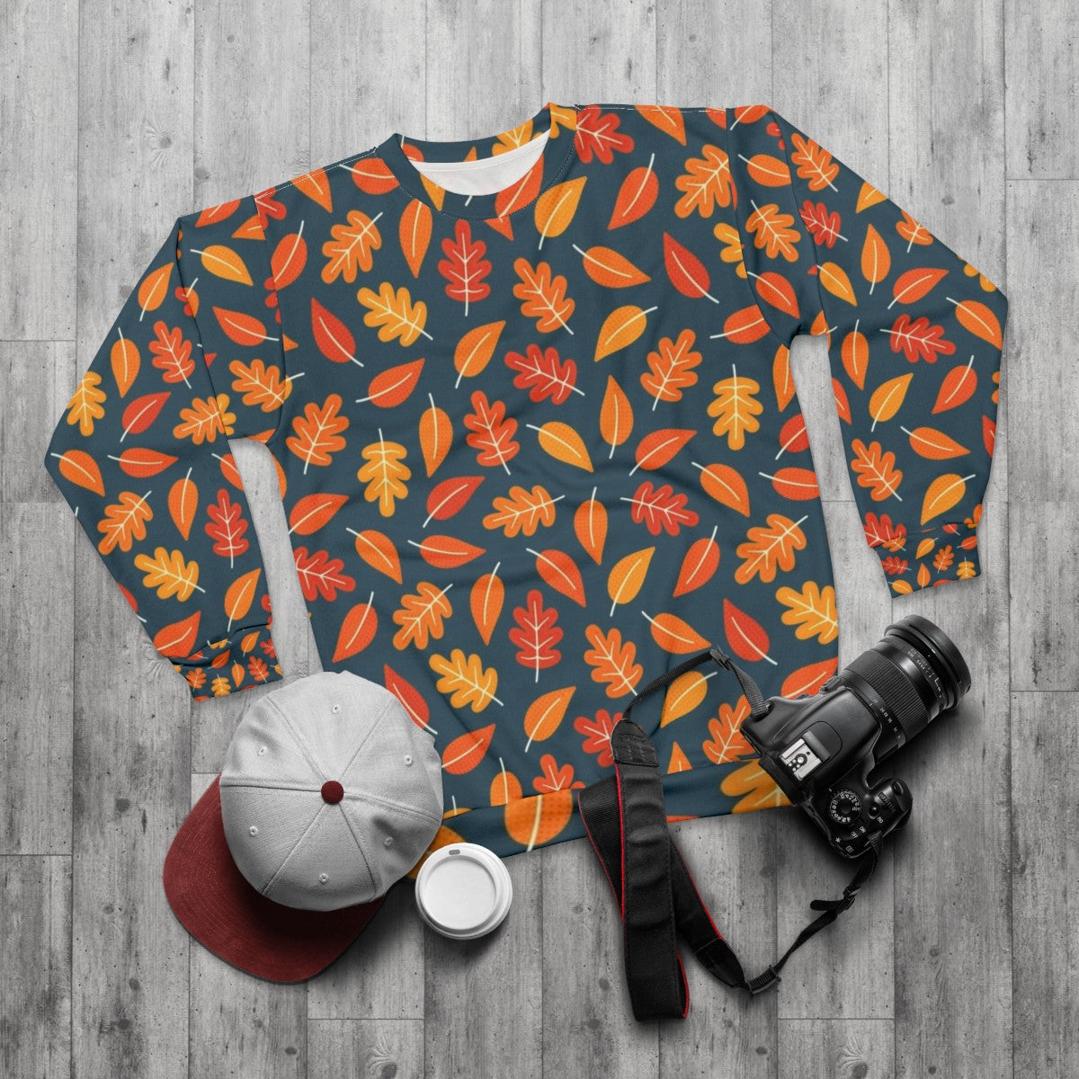 Retro autumn leaves on indigo blue sweatshirt - flat lay