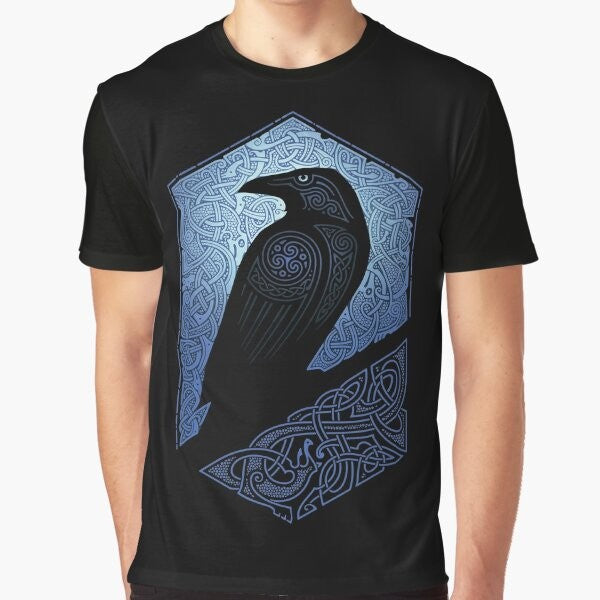 A graphic t-shirt featuring a silhouette of a raven or crow against a blue and black background with celtic and tribal design elements.