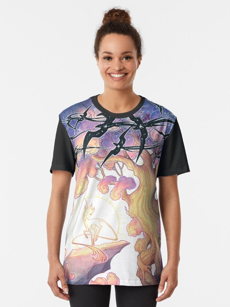 A graphic t-shirt featuring a fantasy design with a night sky, stars, and mythical creatures like unicorns and birds. - Women