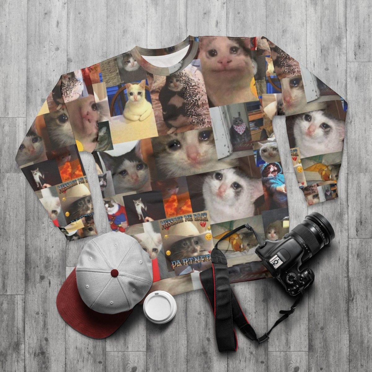 Crying cat meme printed on a cozy sweatshirt - flat lay