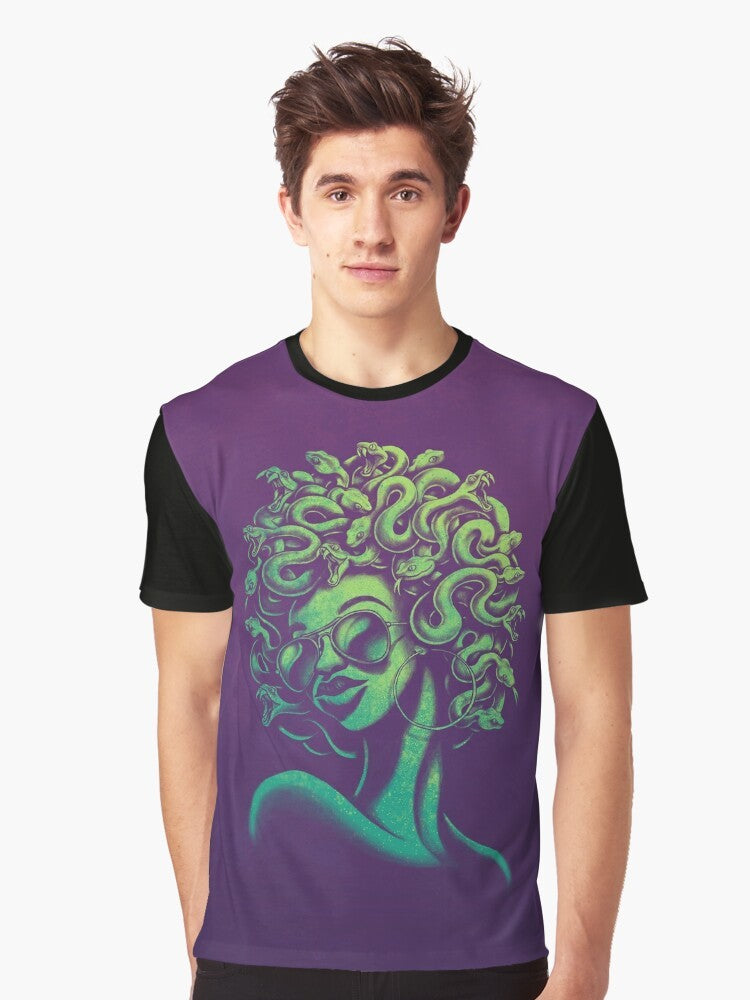 A funky and retro-inspired graphic t-shirt featuring the mythical Medusa character with an afro hairstyle and aviator sunglasses. - Men