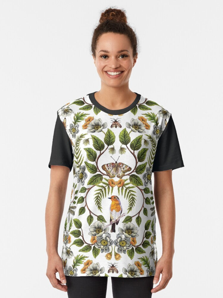 Graphic t-shirt featuring a botanical and floral pattern with birds, moths, dragonflies, and flowers in spring colors of orange, green, and brown. - Women