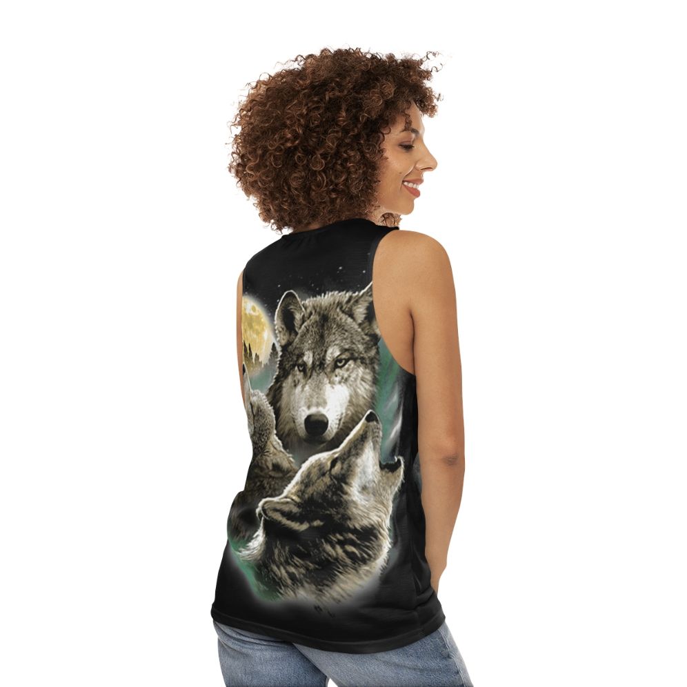 Unisex tank top with three wolves howling at the full moon in the wilderness - women back