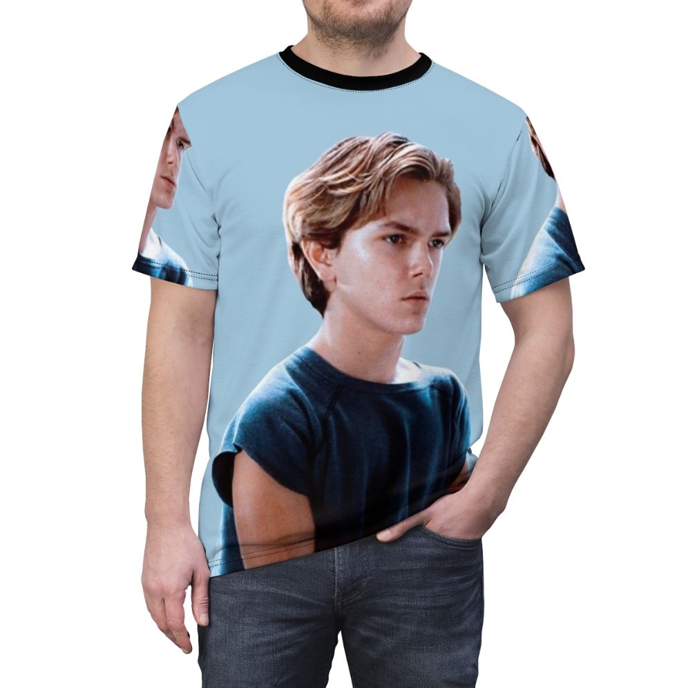 Artistic portrait of River Phoenix, a beloved actor from the 80s and 90s, on a high-quality t-shirt - men front