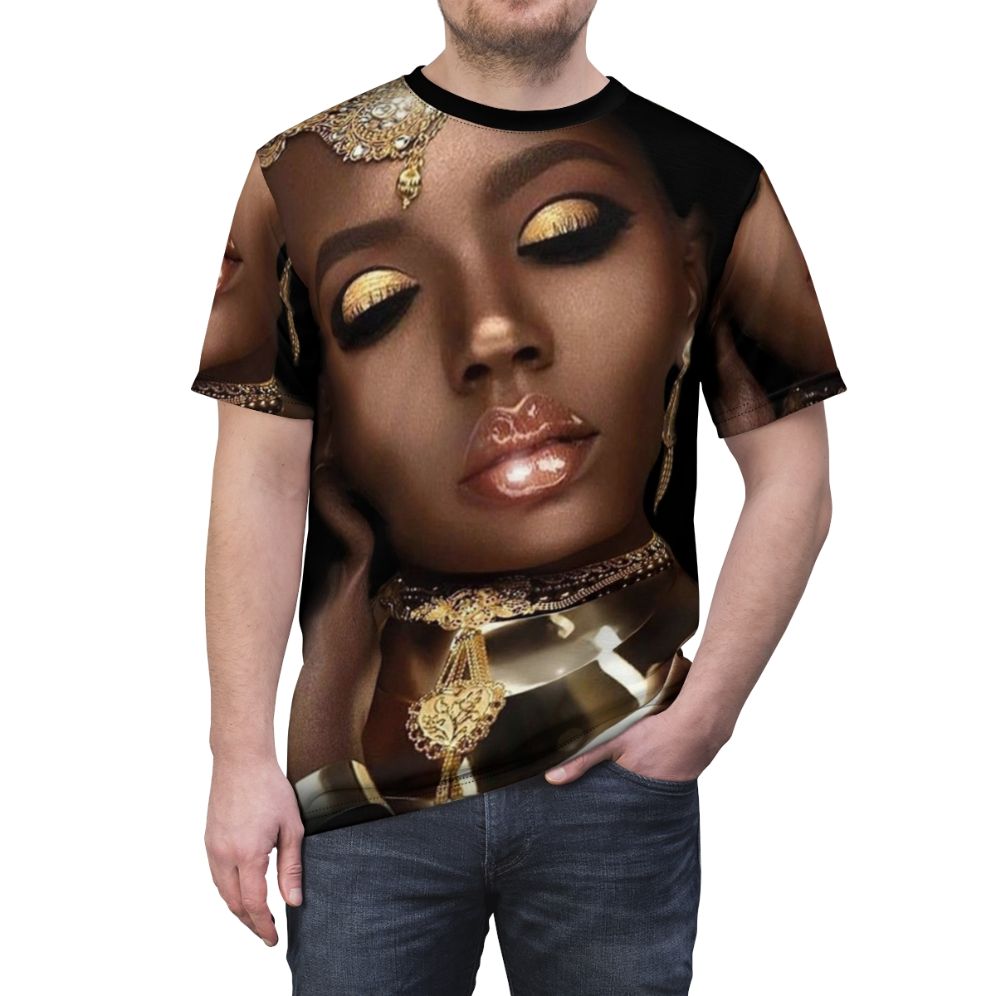 A vibrant and artistic t-shirt design featuring the face of an African queen or goddess with abstract patterns, jewelry, and cultural elements. - men front