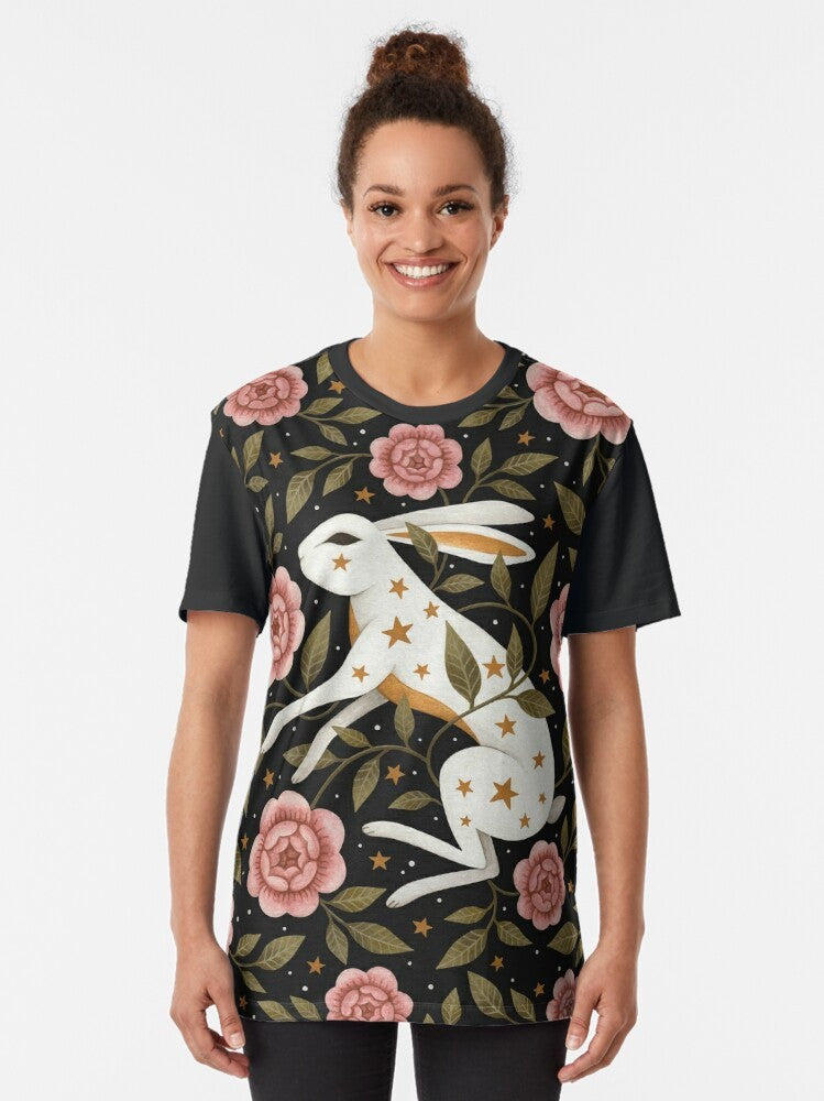 Graphic t-shirt featuring an entangled rabbit in a magical, floral landscape with stars and laurel - Women