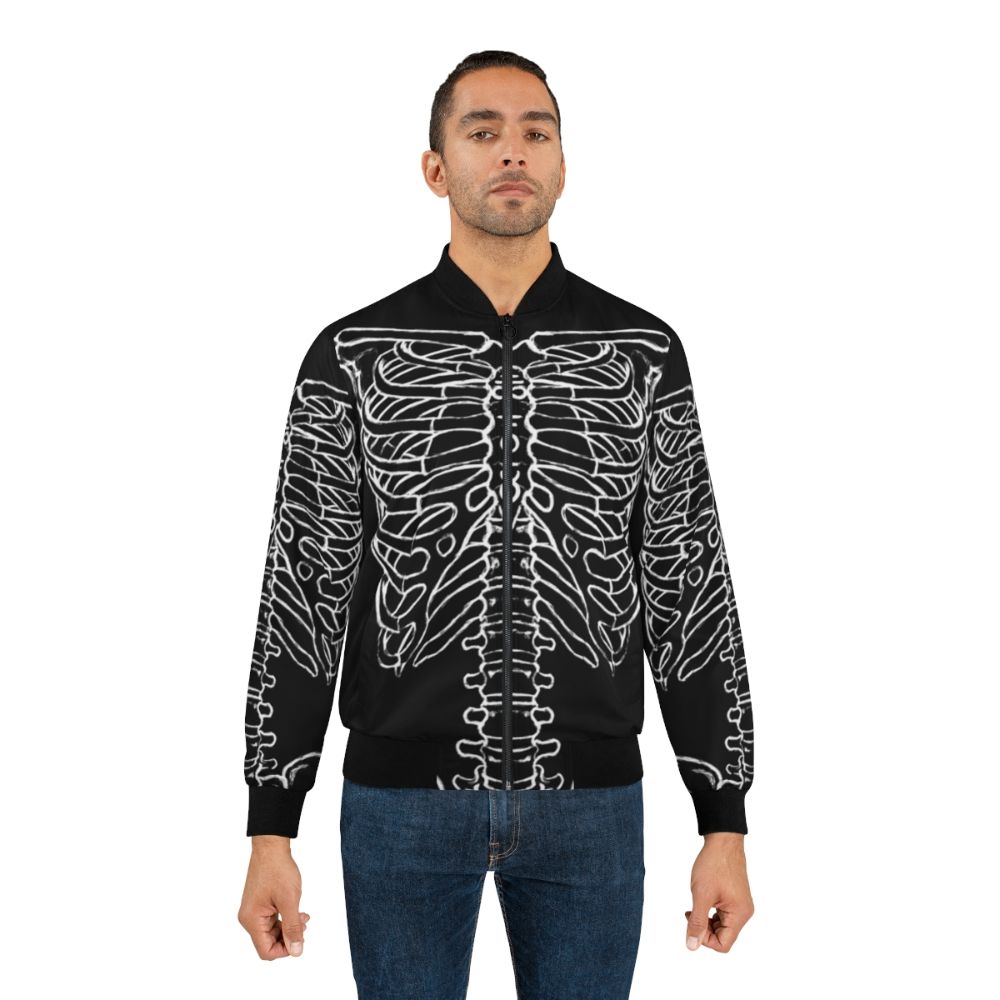 A black bomber jacket featuring a skeleton rib cage design, perfect for a dark and spooky Halloween look. - Lifestyle