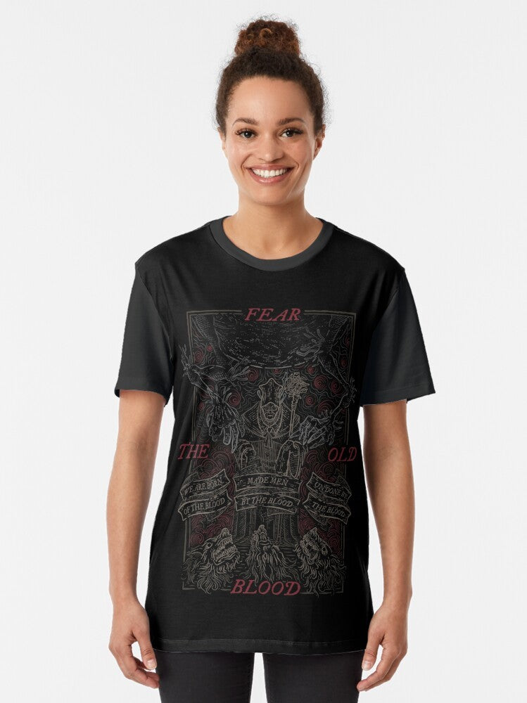 A vintage-style graphic t-shirt featuring the Bloodborne logo and Lovecraftian imagery of the "old blood". - Women