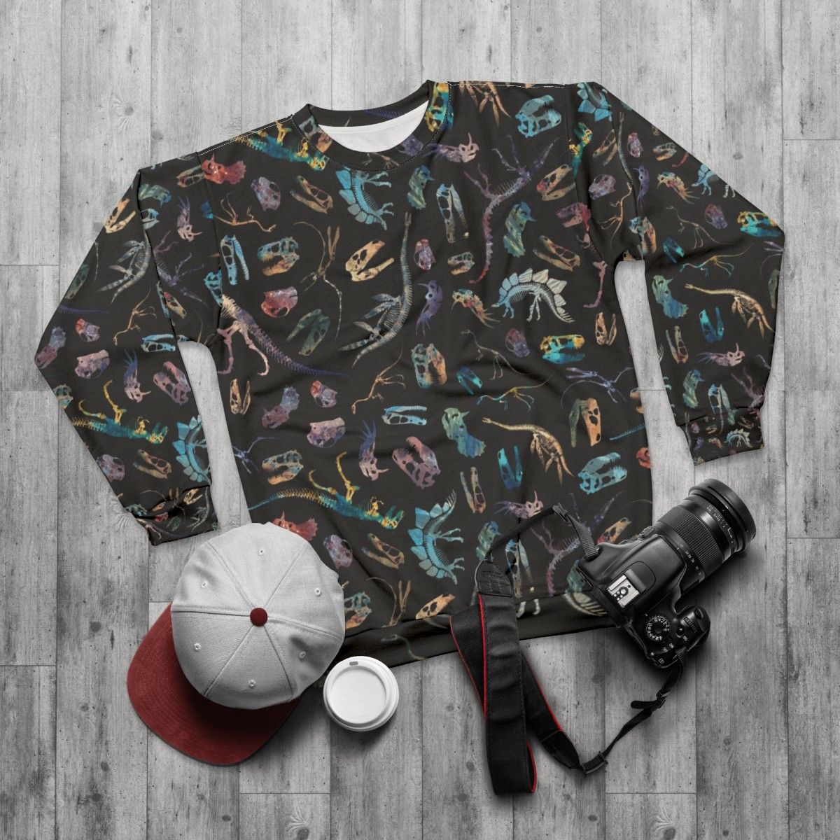 Dark sweatshirt with minimalist dinosaur fossil silhouette pattern - flat lay