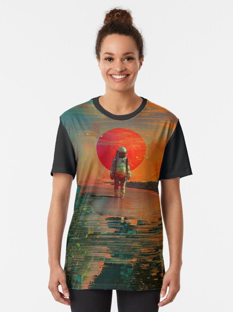 A surreal, visually striking graphic t-shirt featuring an astronaut in a collage-style space scene with planets, stars, and a cosmic blast. - Women