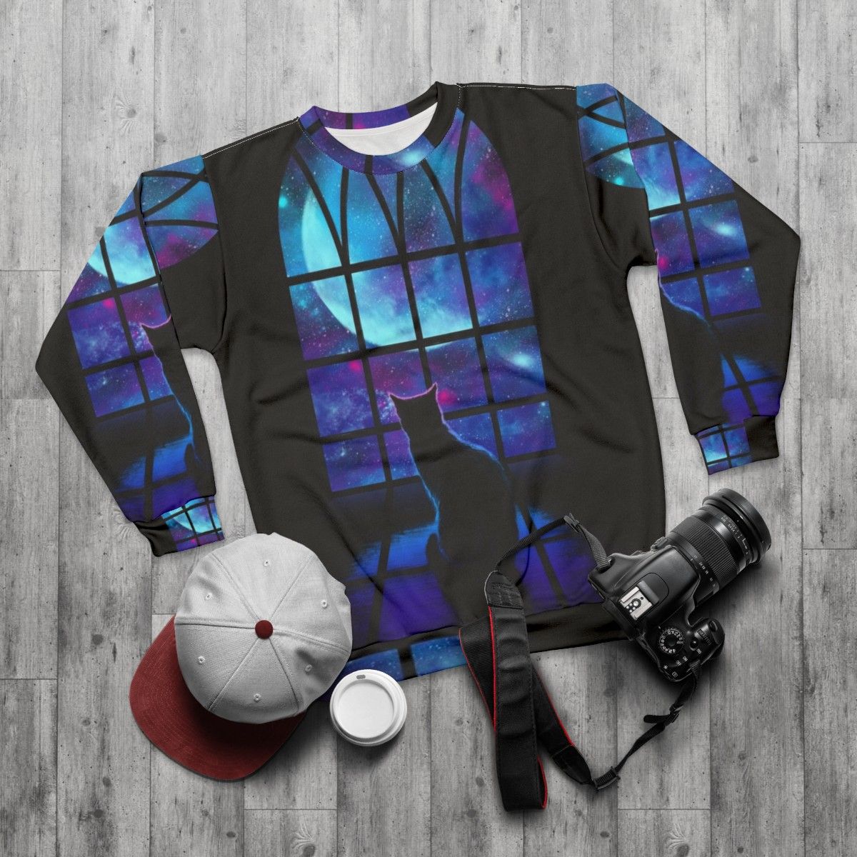 A stylish space-themed sweatshirt with a cute cat design - flat lay